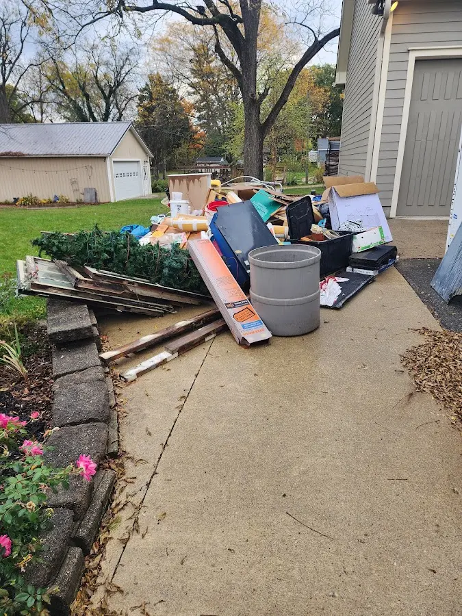 Dumpster being loaded with debris for 10 Yard Dumpster Rental in Nassau